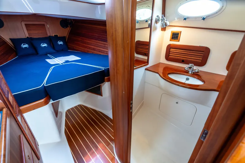 Sometimes Yacht Photos Pics Luxurious 2007 Hinckley Picnic Boat EP interior with cozy cabin and elegant wood finishes.