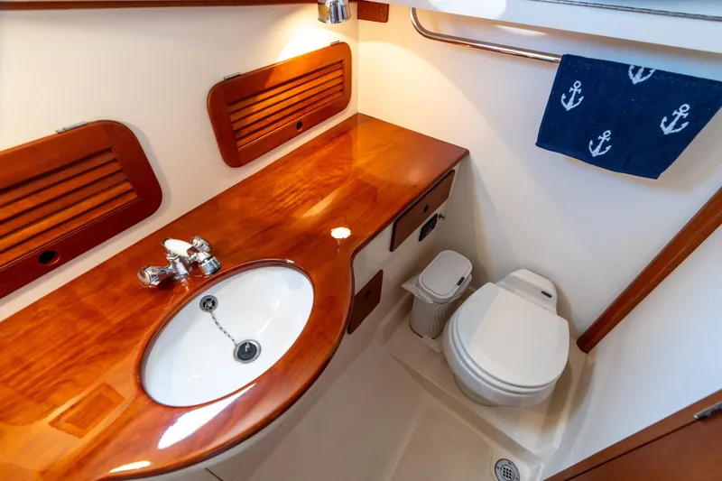 Sometimes Yacht Photos Pics 2007 Hinckley Picnic Boat EP bathroom with wooden countertop, sink, and toilet.