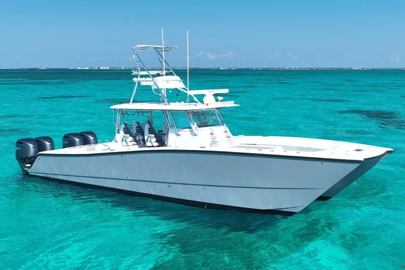  Yacht Photos Pics 2024 Freeman 42 boat on clear turquoise water, featuring multiple outboard engines.