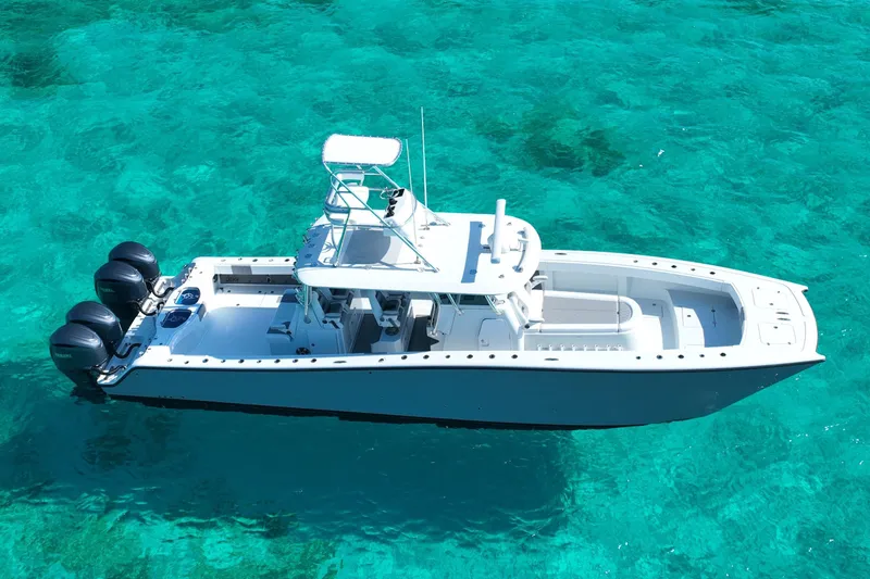  Yacht Photos Pics 2024 Freeman 42 boat on clear turquoise water, showcasing sleek design and powerful engines.