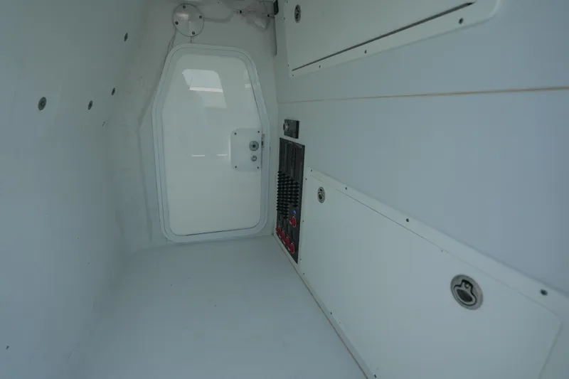  Yacht Photos Pics Interior of 2024 Freeman 42 boat, featuring white panels and a closed door.