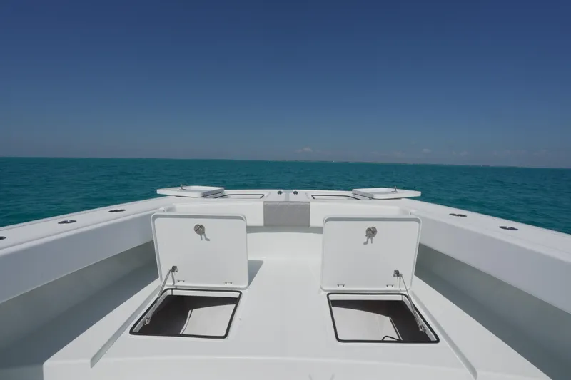  Yacht Photos Pics 2024 Freeman 42 boat deck with open storage compartments, set against a clear blue ocean.