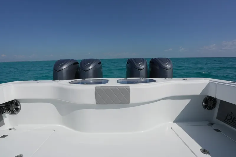  Yacht Photos Pics 2024 Freeman 42 boat with four engines on open sea under clear sky.