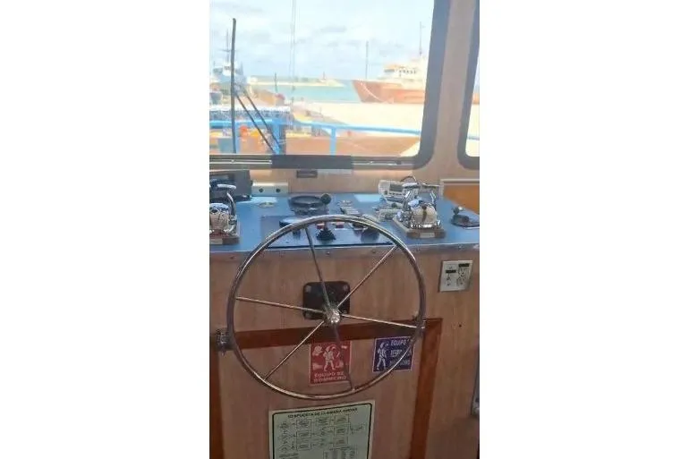  Yacht Photos Pics Bridge of 2004 Custom Built Offshore Crew Vessel with steering wheel and controls.