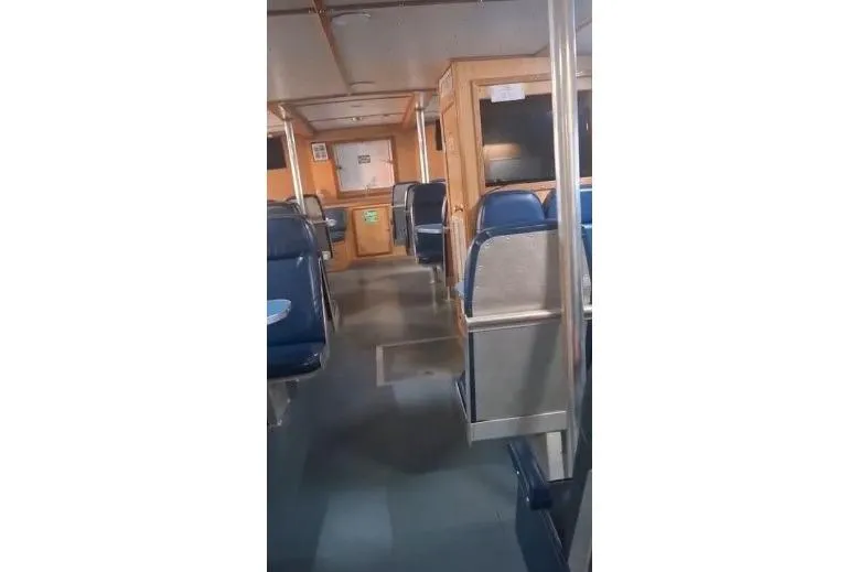  Yacht Photos Pics Interior of a 2004 custom-built offshore crew vessel with blue seating and wooden paneling.