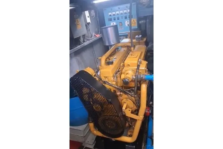  Yacht Photos Pics Yellow engine inside a 2004 custom-built offshore crew vessel, showcasing mechanical components.