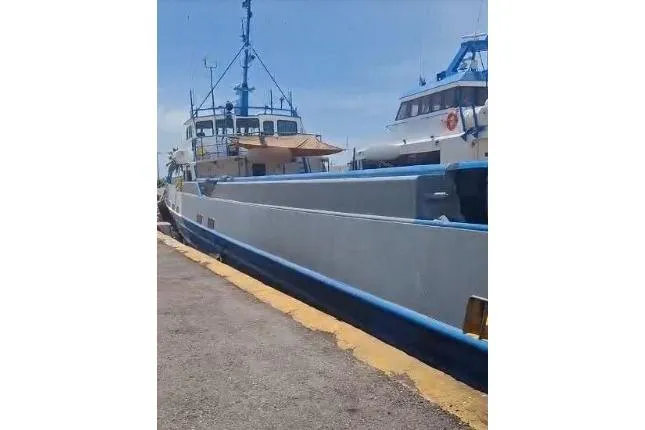  Yacht Photos Pics Custom built offshore crew vessel docked, 2004 model, with blue and white exterior.