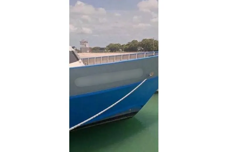  Yacht Photos Pics Custom Built Offshore Crew Vessel, 2004, docked with blue hull and clear sky background.