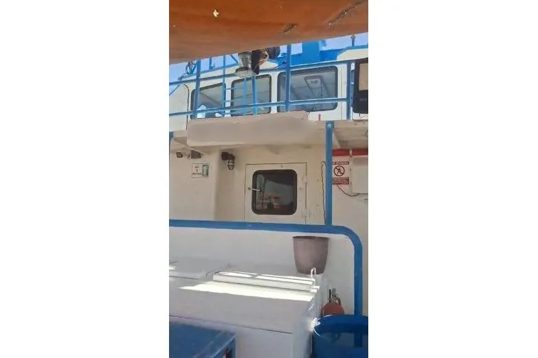  Yacht Photos Pics Custom built offshore crew vessel, 2004, featuring blue and white exterior with safety equipment.