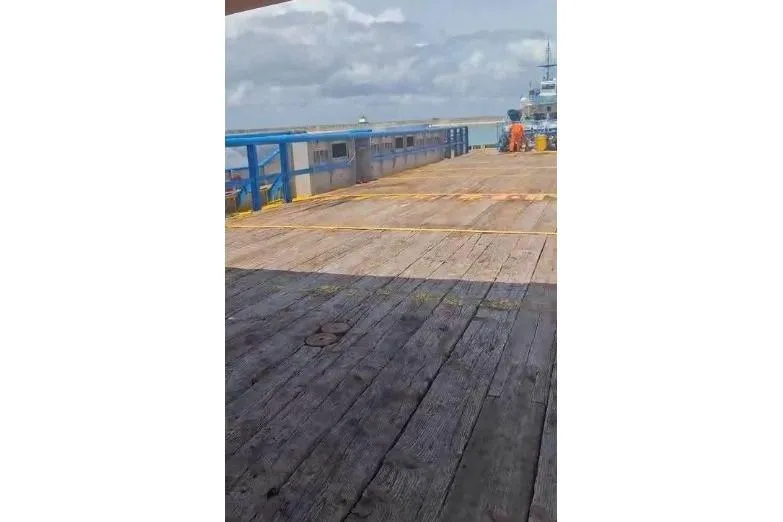  Yacht Photos Pics Custom built offshore crew vessel deck, 2004 model, with blue railings and wooden flooring.