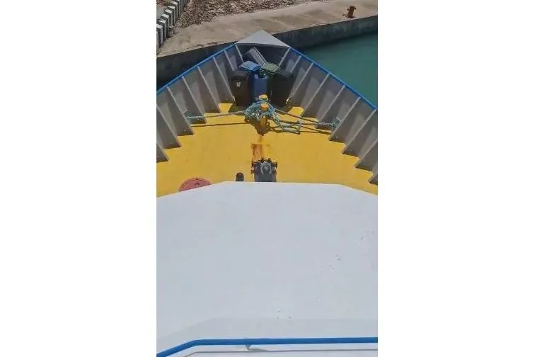  Yacht Photos Pics Custom Built Offshore Crew Vessel, 2004, docked with yellow deck and visible mooring equipment.