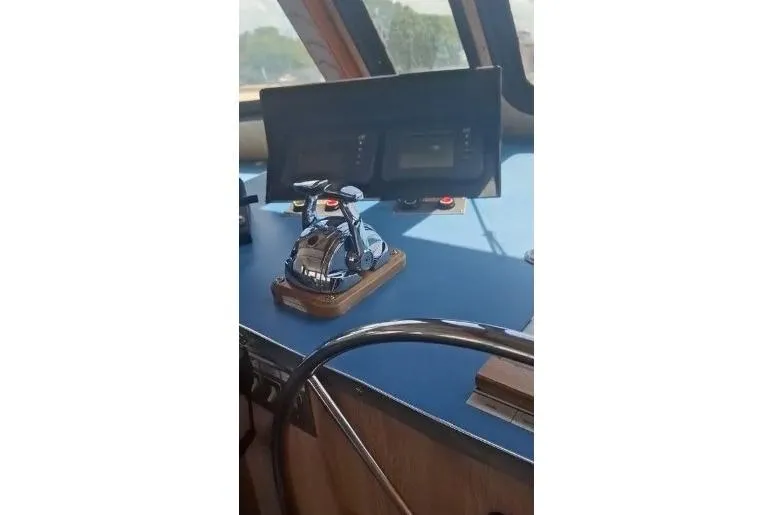  Yacht Photos Pics Control panel of a 2004 custom-built offshore crew vessel with steering wheel and navigation equipment.