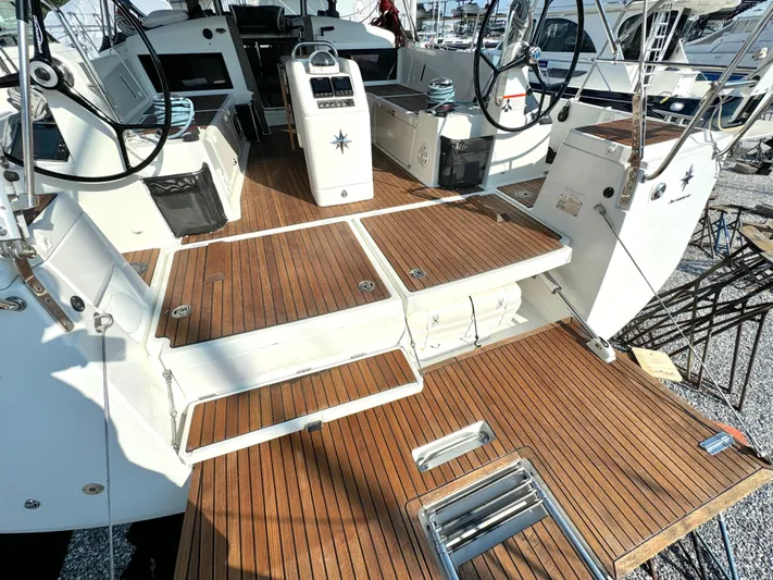 Leopolis Yacht Photos Pics Jeanneau Sun Odyssey 440, 2019, featuring elegant teak deck and modern helm.