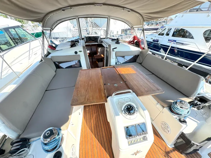 Leopolis Yacht Photos Pics Jeanneau Sun Odyssey 440, 2019, spacious cockpit with wooden table and helm console.
