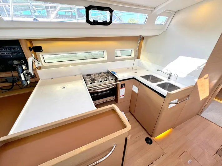 Leopolis Yacht Photos Pics Interior view of Jeanneau Sun Odyssey 440 yacht kitchen, 2019 model.
