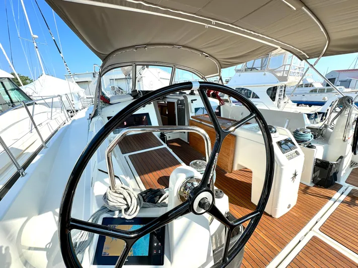 Leopolis Yacht Photos Pics Cockpit of 2019 Jeanneau Sun Odyssey 440 with steering wheel and wooden deck.