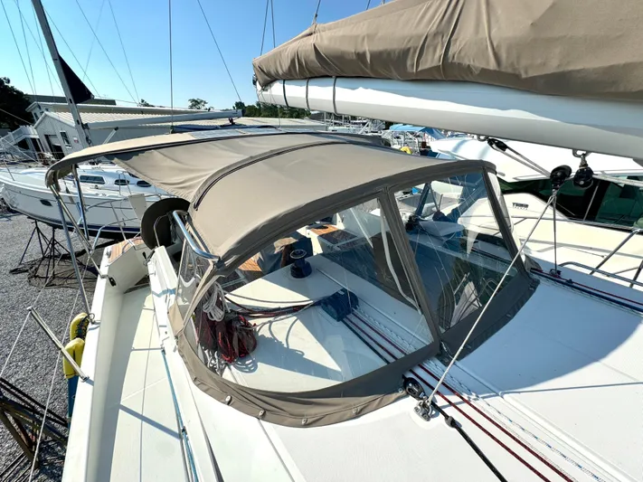 Leopolis Yacht Photos Pics Jeanneau Sun Odyssey 440 sailboat, 2019 model, with canopy in harbor.