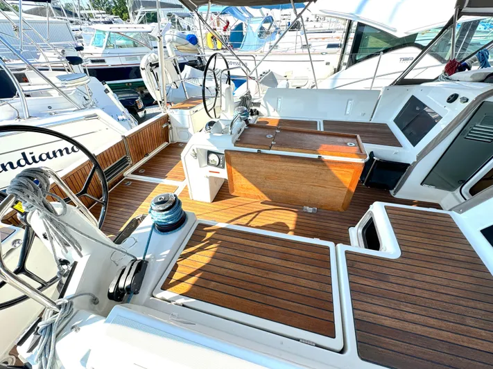 Leopolis Yacht Photos Pics Cockpit of 2019 Jeanneau Sun Odyssey 440 Performance sailboat with wooden deck and dual steering wheels.