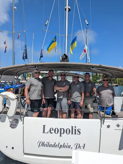 Leopolis Yacht Photos Pics Group of men on Jeanneau Sun Odyssey 440 Performance sailboat, "Leopolis," in marina.