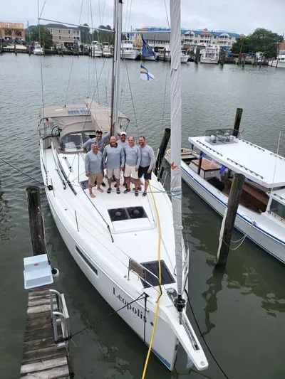 Leopolis Yacht Photos Pics 2019 Jeanneau Sun Odyssey 440 Performance sailboat with crew docked at marina.