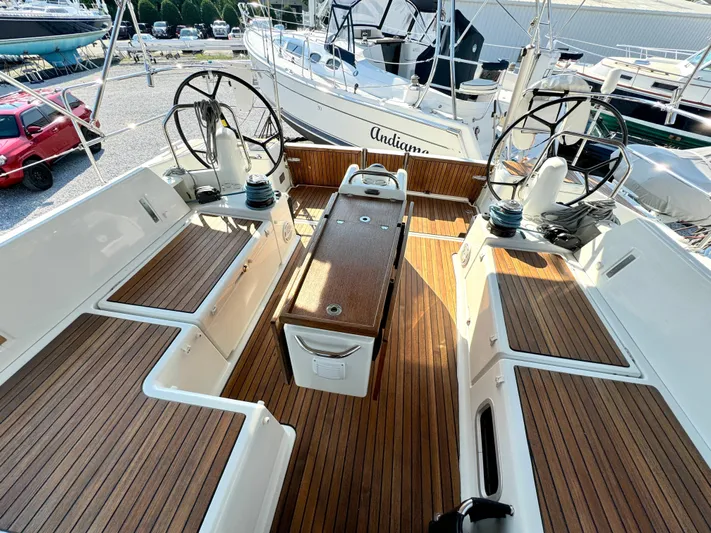 Leopolis Yacht Photos Pics 2019 Jeanneau Sun Odyssey 440 Performance sailboat cockpit with dual steering wheels and teak flooring.