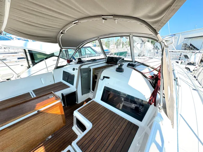 Leopolis Yacht Photos Pics 2019 Jeanneau Sun Odyssey 440 Performance sailboat cockpit with wood accents and canopy.