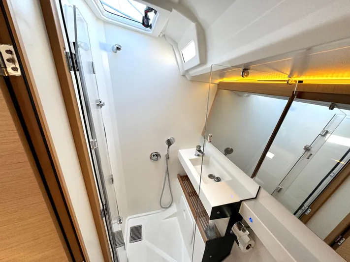 Leopolis Yacht Photos Pics Modern bathroom in 2019 Jeanneau Sun Odyssey 440 Performance yacht, featuring sleek design and lighting.