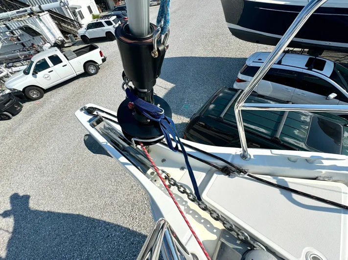 Leopolis Yacht Photos Pics Bow of 2019 Jeanneau Sun Odyssey 440 Performance sailboat with rigging and parked vehicles.