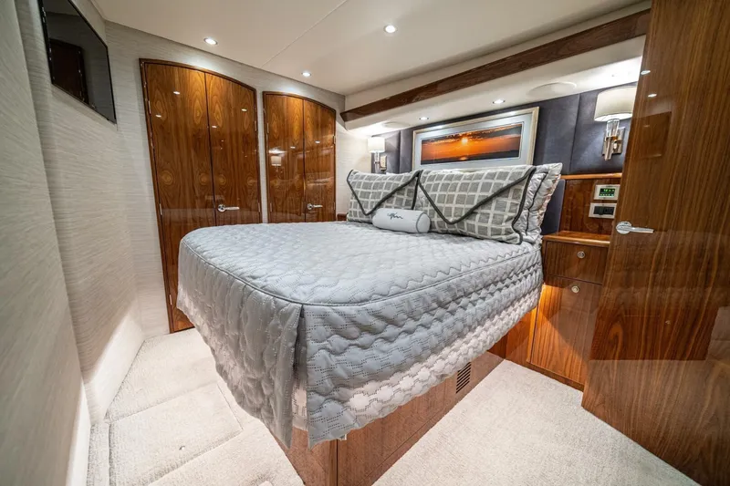 Galati Yacht Sales Trade Yacht Photos Pics Luxurious bedroom interior of 2021 Viking 58 Convertible yacht with elegant wood finishes.