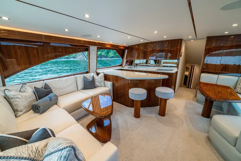 Galati Yacht Sales Trade Yacht Photos Pics Luxurious interior of 2021 Viking 58 Convertible yacht with elegant seating and wood finishes.