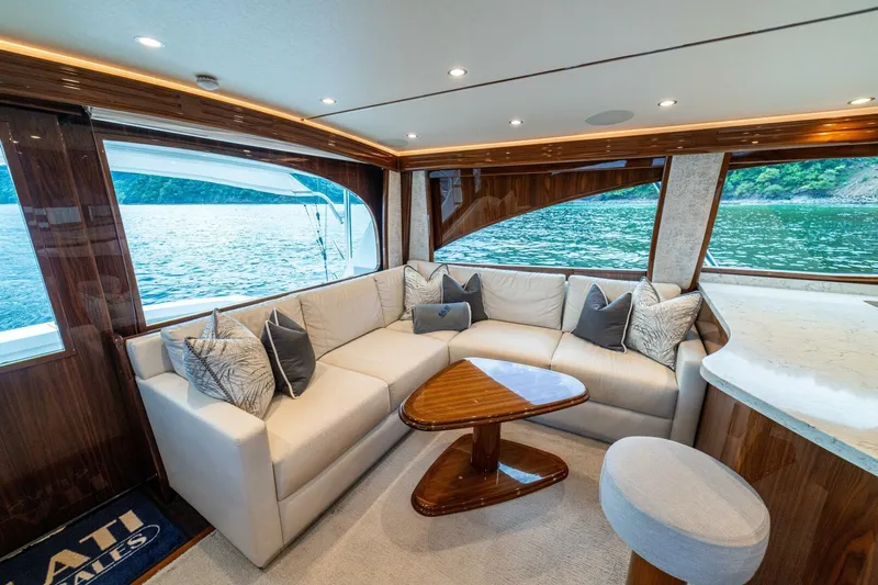 Galati Yacht Sales Trade Yacht Photos Pics Luxurious interior of 2021 Viking 58 Convertible yacht with elegant seating and scenic water view.