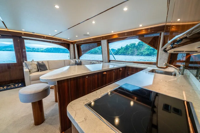 Galati Yacht Sales Trade Yacht Photos Pics Luxurious interior of 2021 Viking 58 Convertible yacht with modern kitchen and scenic ocean view.