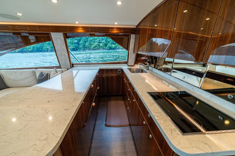 Galati Yacht Sales Trade Yacht Photos Pics Luxurious interior of 2021 Viking 58 Convertible yacht with modern kitchen and scenic view.