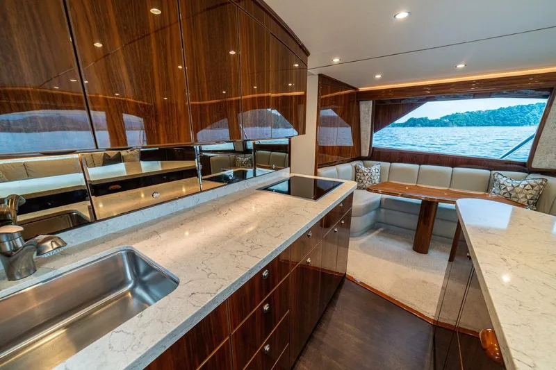 Galati Yacht Sales Trade Yacht Photos Pics Luxurious interior of 2021 Viking 58 Convertible yacht with elegant wood finishes and scenic views.