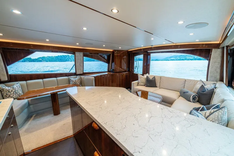 Galati Yacht Sales Trade Yacht Photos Pics Luxurious interior of 2021 Viking 58 Convertible yacht with elegant seating and ocean view.
