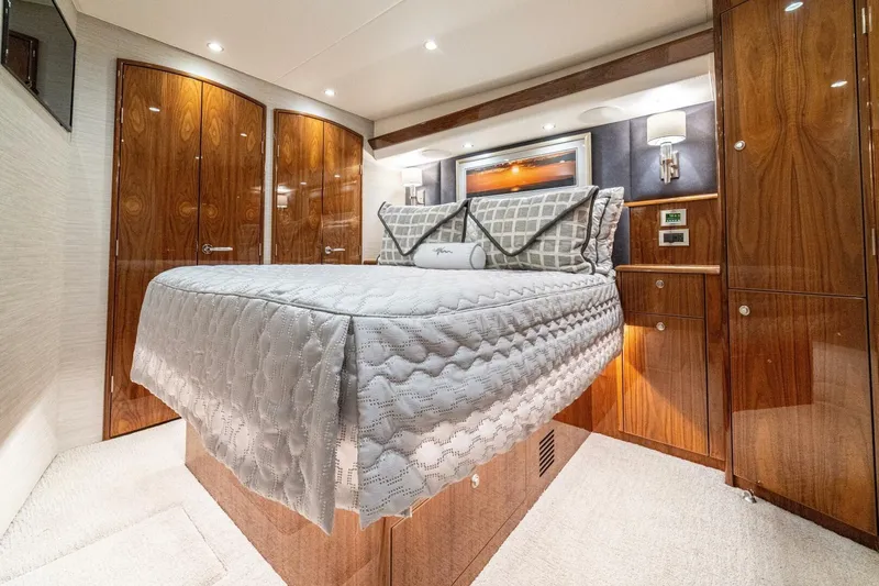 Galati Yacht Sales Trade Yacht Photos Pics Luxurious bedroom interior of 2021 Viking 58 Convertible yacht with elegant wood finishes.