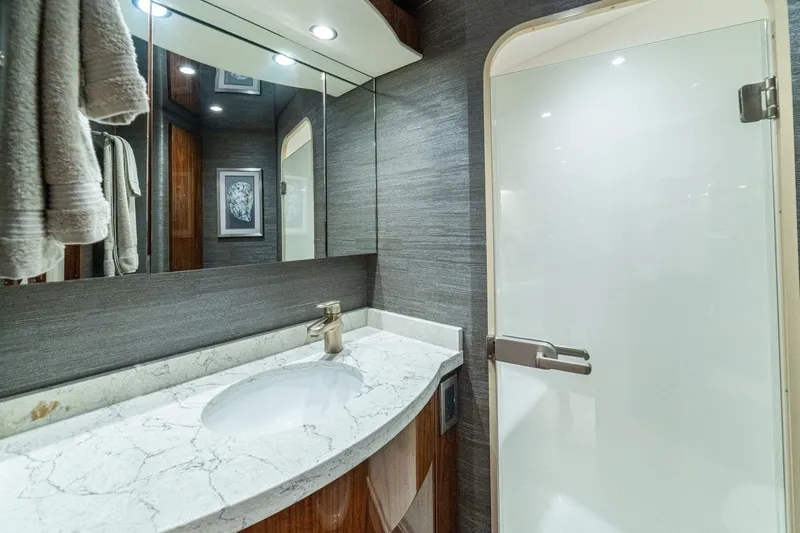 Galati Yacht Sales Trade Yacht Photos Pics Luxurious bathroom in 2021 Viking 58 Convertible yacht with marble countertop and modern fixtures.
