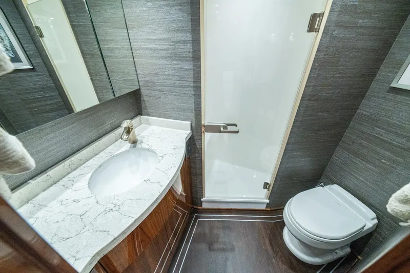 Galati Yacht Sales Trade Yacht Photos Pics Luxurious bathroom in 2021 Viking 58 Convertible yacht with marble countertop and modern fixtures.