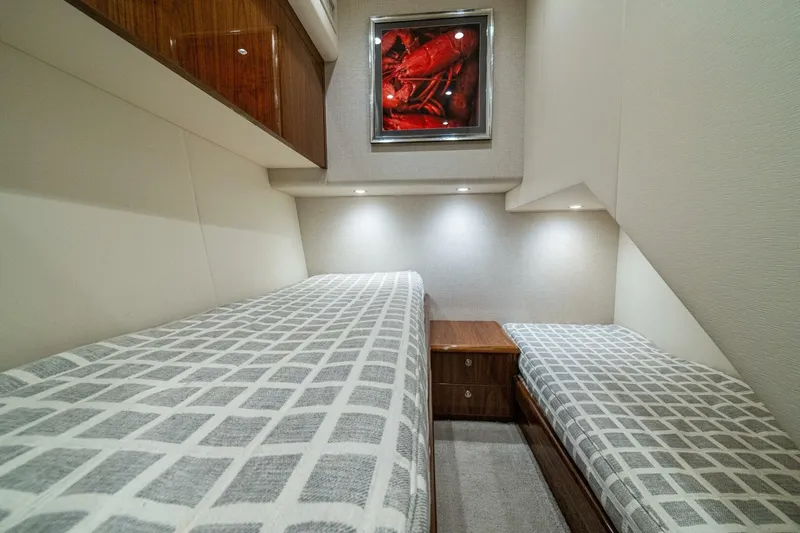 Galati Yacht Sales Trade Yacht Photos Pics Luxurious 2021 Viking 58 Convertible yacht cabin with twin beds and modern decor.