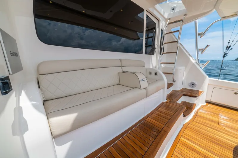 Galati Yacht Sales Trade Yacht Photos Pics Luxurious seating and teak steps on 2021 Viking 58 Convertible yacht deck.