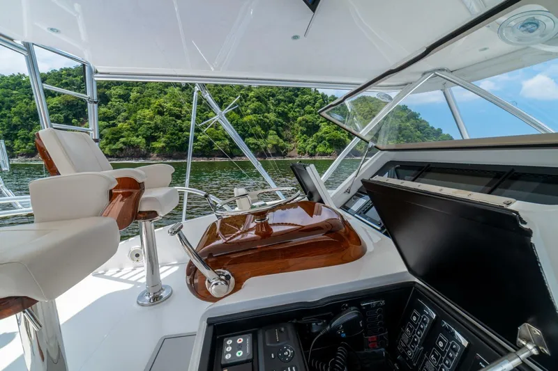 Galati Yacht Sales Trade Yacht Photos Pics 2021 Viking 58 Convertible yacht helm with luxurious seating and scenic water view.