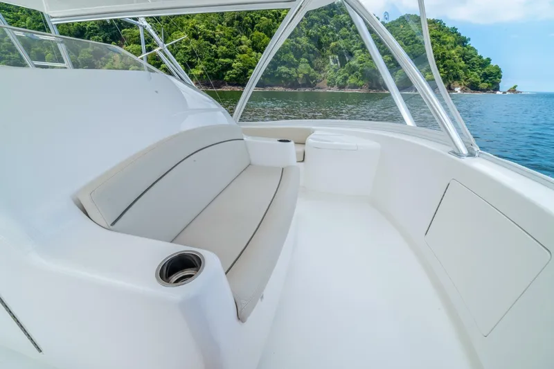 Galati Yacht Sales Trade Yacht Photos Pics 2021 Viking 58 Convertible yacht interior with seating, ocean view, and lush greenery.