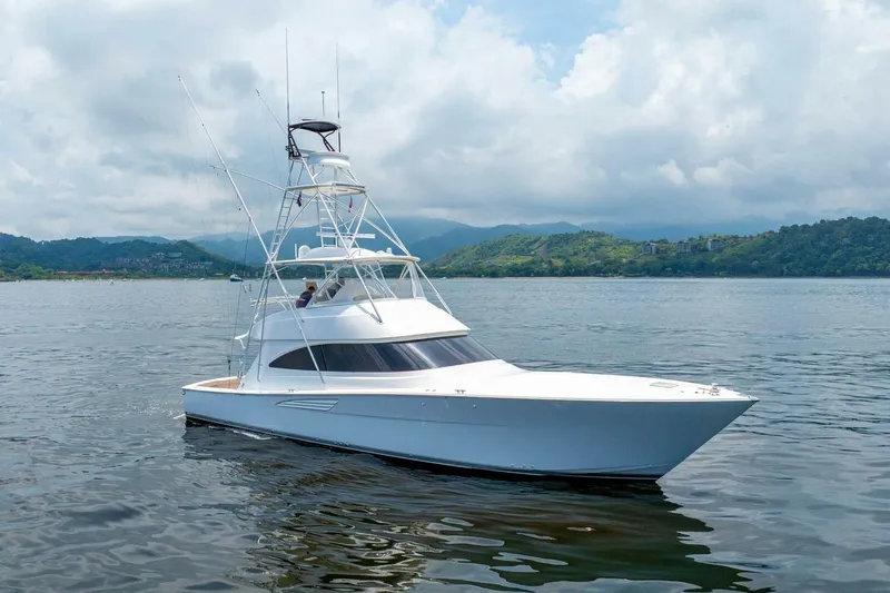 Galati Yacht Sales Trade Yacht Photos Pics 2021 Viking 58 Convertible yacht on calm water with scenic mountain backdrop.