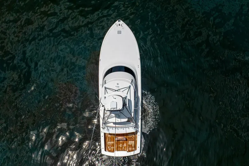 Galati Yacht Sales Trade Yacht Photos Pics Aerial view of 2021 Viking 58 Convertible yacht cruising on dark water.