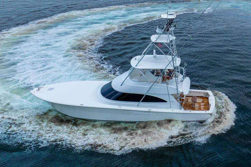 Galati Yacht Sales Trade Yacht Photos Pics 2021 Viking 58 Convertible yacht cruising on open water, creating a circular wake.