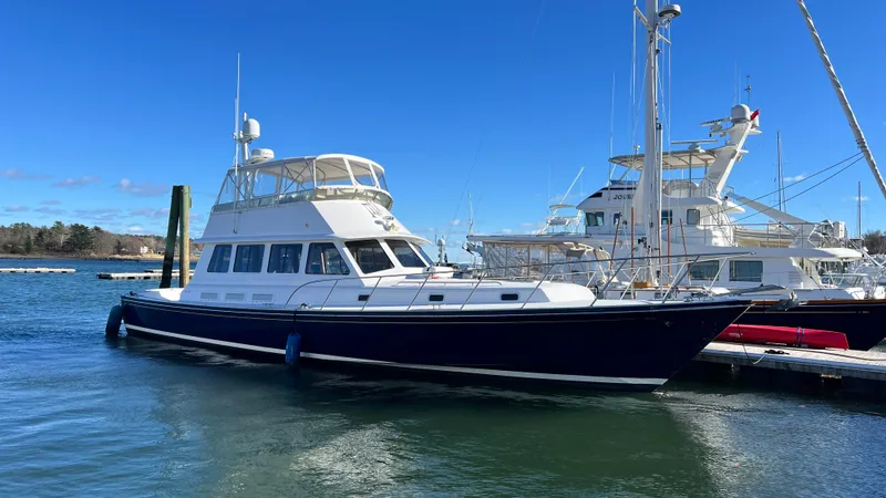 La Vie Dansante Yacht Photos Pics 1998 Little Harbor WhisperJet 55 yacht docked in a marina under clear blue skies.