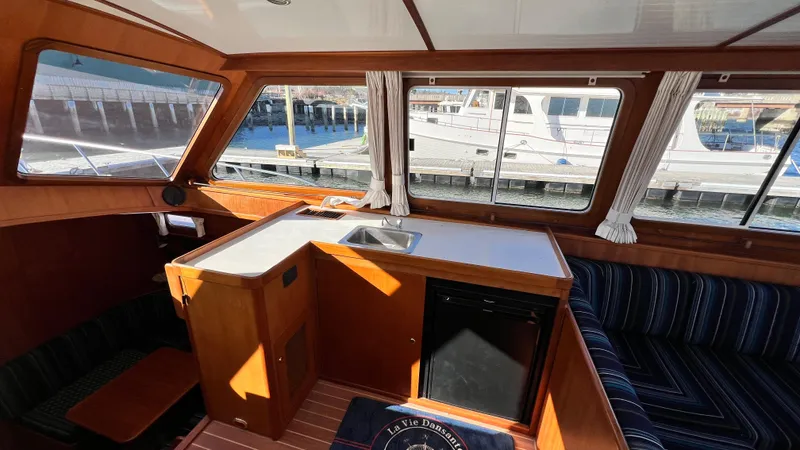 La Vie Dansante Yacht Photos Pics Interior of 1998 Little Harbor WhisperJet 55 yacht with wood finish and seating area.