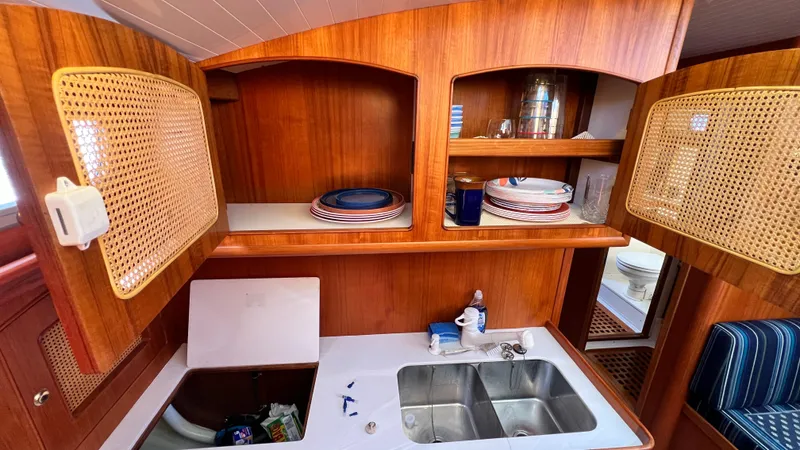 La Vie Dansante Yacht Photos Pics Interior of 1998 Little Harbor WhisperJet 55 yacht kitchen with wooden cabinets and dual sink.