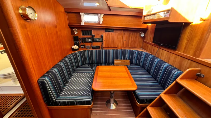 La Vie Dansante Yacht Photos Pics 1998 Little Harbor WhisperJet 55 interior with wood finish and striped seating.