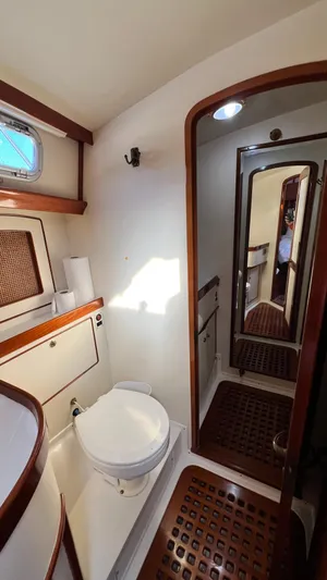 La Vie Dansante Yacht Photos Pics Bathroom interior of 1998 Little Harbor WhisperJet 55 yacht, featuring wooden accents and compact design.